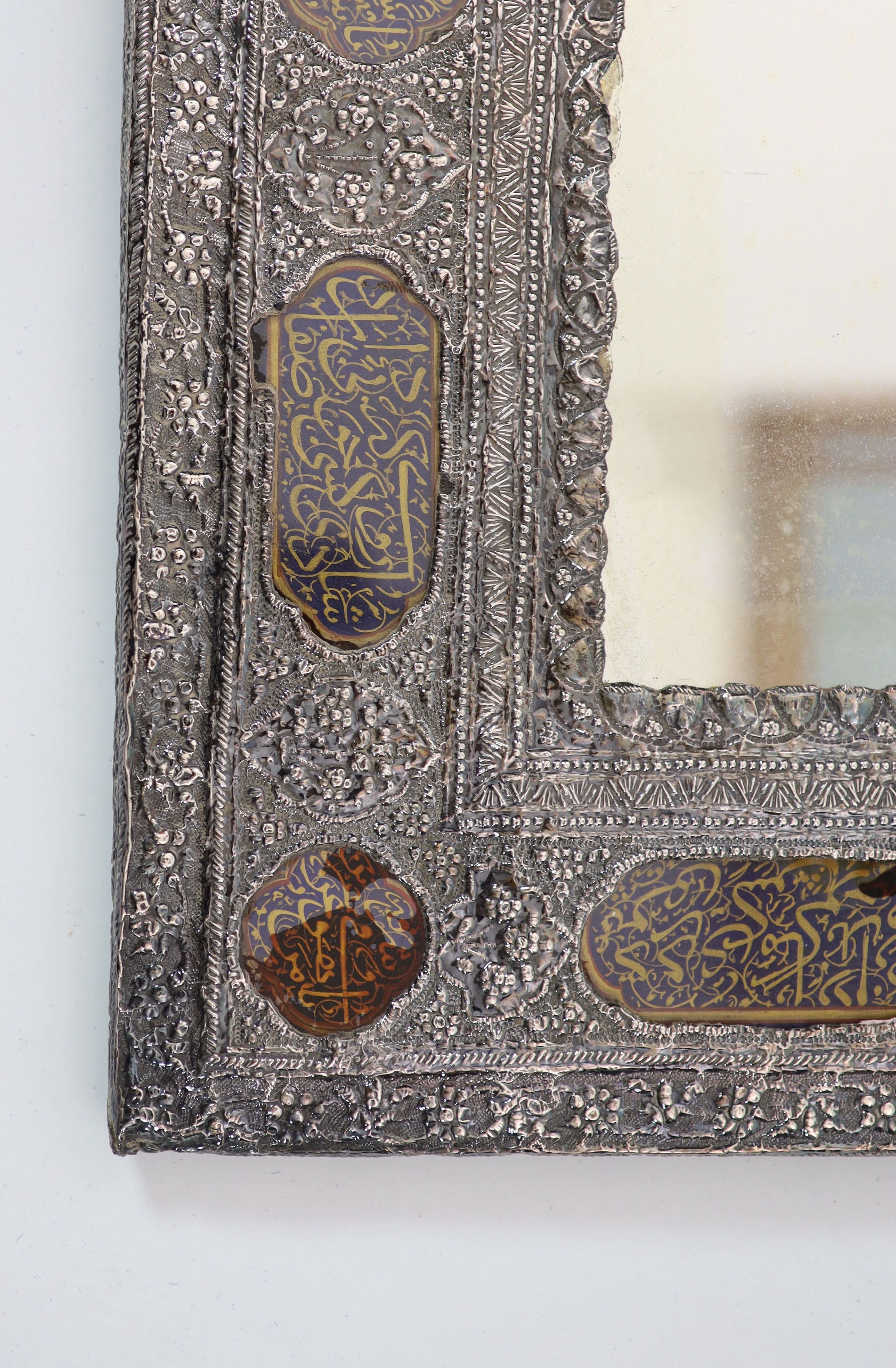 A Persian repousse white metal wall mirror, first half 20th century,